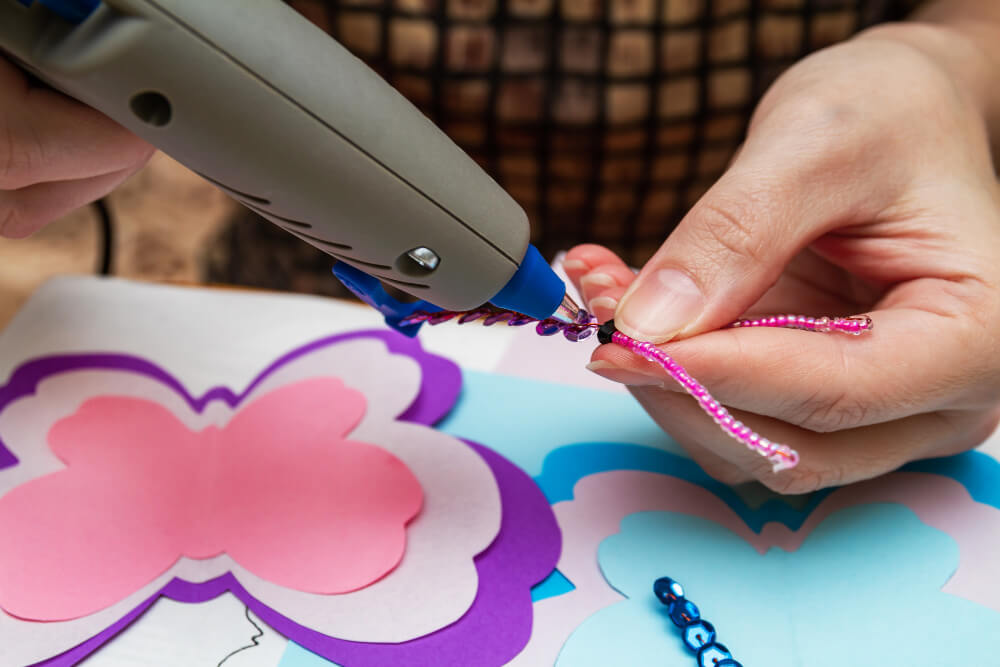 Sticking beads and pipe cleaners with a hot glue gun